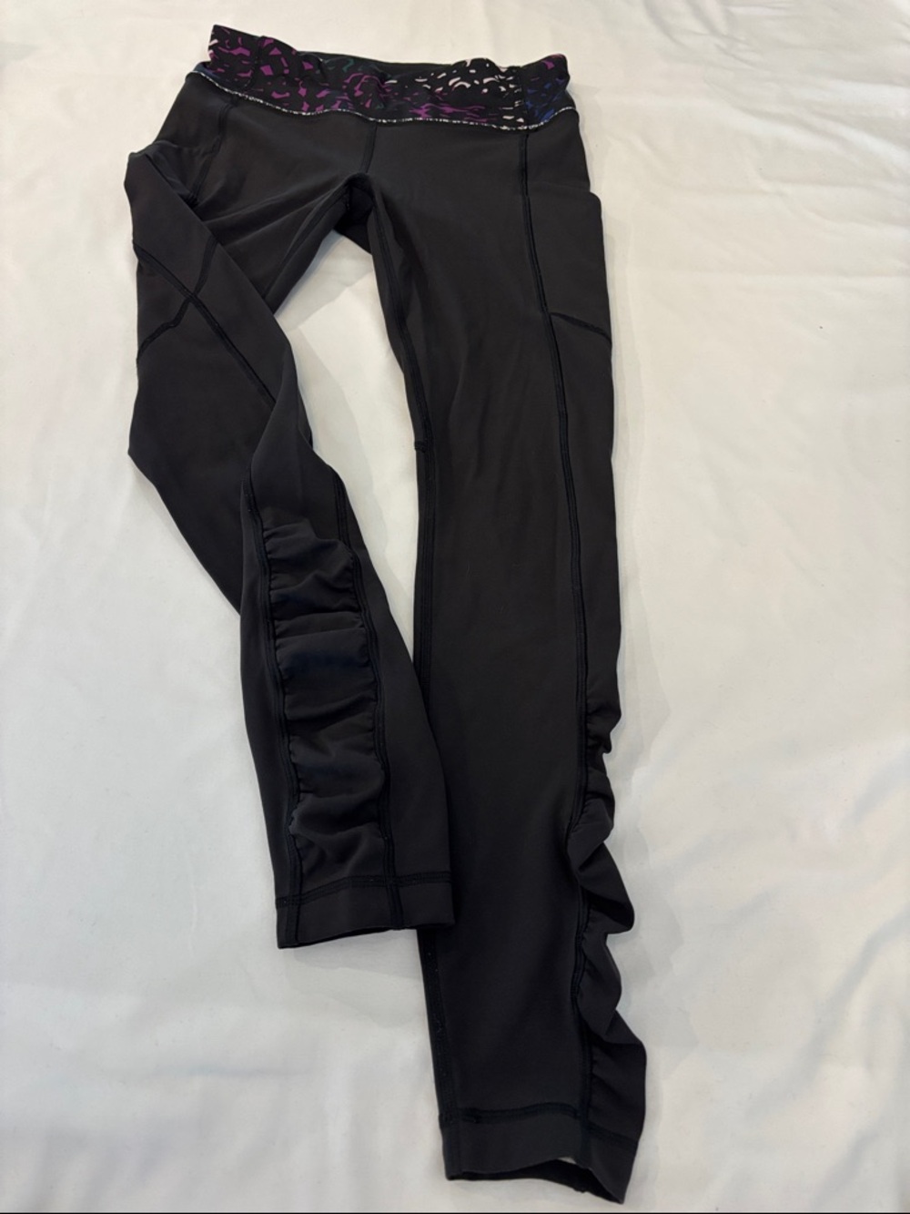 Lululemon womenโs black ruffled Athleisure leggings with colorful waistband- 6